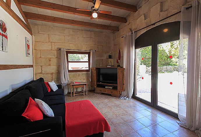 Open-plan living room with sofa, dining area, kitchen, ornamental fireplace, WiFi internet, satellite TV, DVD player, and terrace access . - Villa Tres Pinos . (Photo Gallery) }}