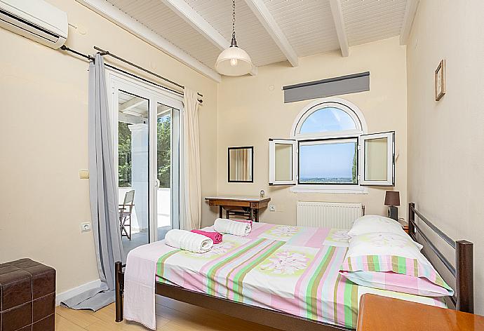 Double bedroom with A/C and balcony access . - Villa Mavrikia . (Photo Gallery) }}