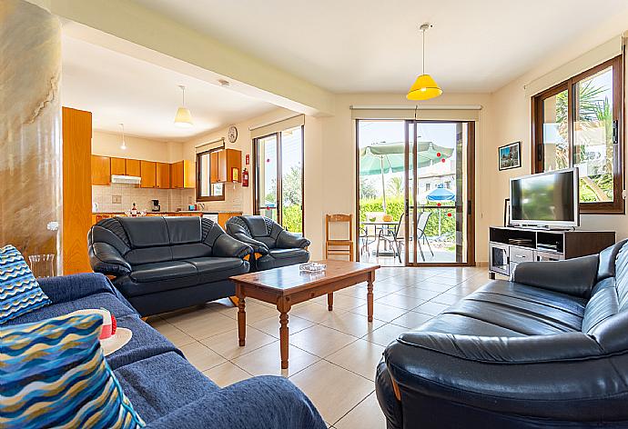 Open-plan living room with sofas, dining area, kitchen, A/C, WiFi internet, satellite TV, and terrace access . - Villa Halima Fostira . (Galleria fotografica) }}