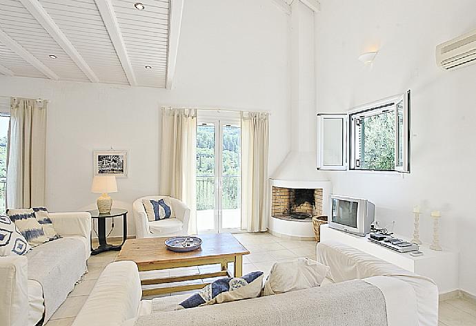 Living room with WiFi, TV, DVD player and balcony access . - Villa Eleonas . (Photo Gallery) }}