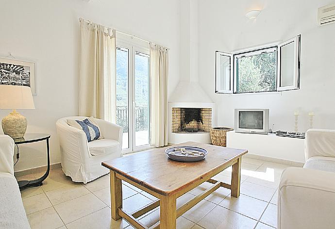 Living room with WiFi, TV, DVD player and balcony access . - Villa Eleonas . (Photo Gallery) }}
