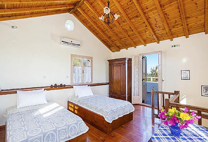 Twin bedroom with balcony access . - Villa Antigoni . (Photo Gallery) }}