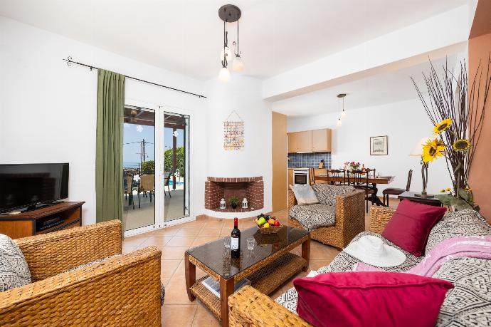 Open-plan living room with sofa, dining area, kitchen, ornamental fireplace, A/C, WiFi internet, and satellite TV . - Villa Thalia Sofia . (Photo Gallery) }}
