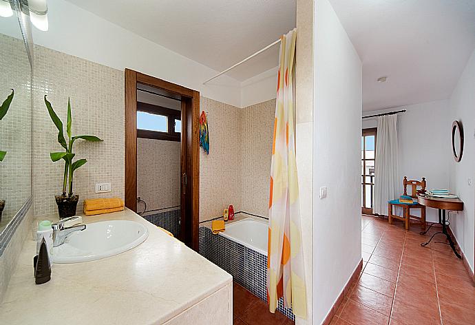 En suite bathroom with bath and shower . - Villa Julianne 4 . (Photo Gallery) }}