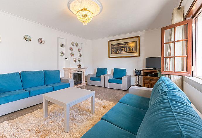 Living room with ornamental fireplace and TV . - Brisa Do Mar . (Photo Gallery) }}