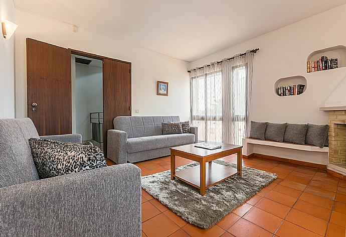 Living room with sofas, dining area, ornamental fireplace, WiFi internet, satellite TV, and DVD player . - Villa Coelho . (Galerie de photos) }}