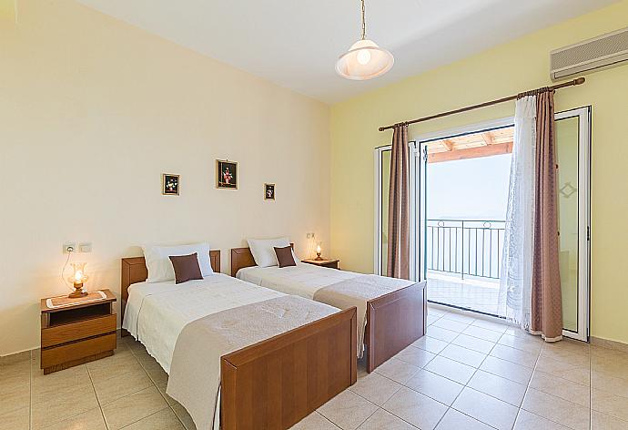 Twin bedroom with A/C and balcony access . - Villa Armandos . (Photo Gallery) }}