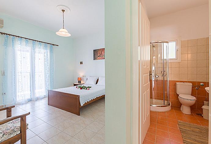 Double bedroom with A/C, en suite bathroom, and balcony access . - Villa Armandos . (Photo Gallery) }}