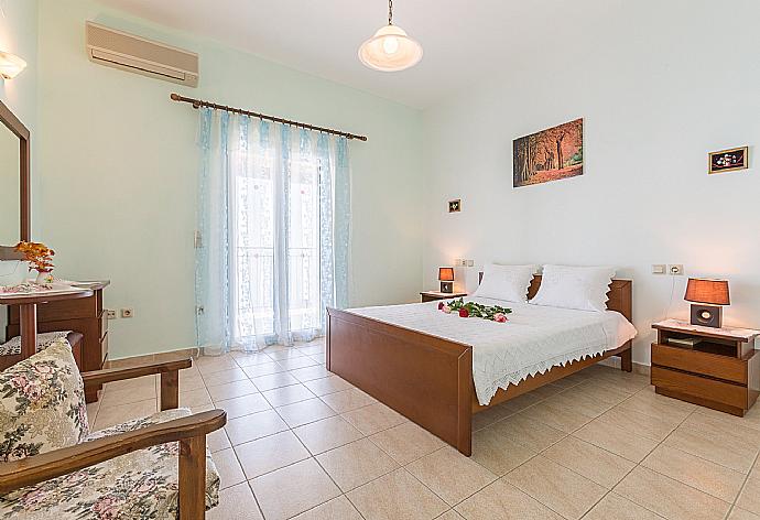 Double bedroom with A/C, en suite bathroom, and balcony access . - Villa Armandos . (Photo Gallery) }}