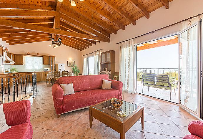 Open-plan living room with WiFi Internet, Satellite TV, DVD player, dining area, equipped kitchen and balcony access . - Villa Armandos . (Galerie de photos) }}