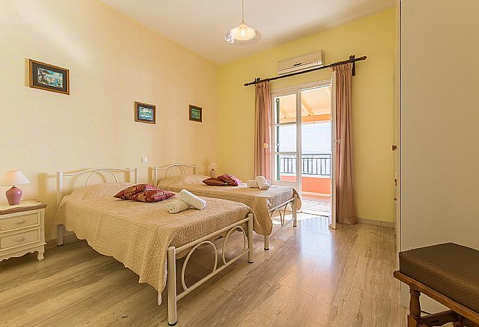 Twin bedroom with balcony access . - Villa Aris . (Photo Gallery) }}