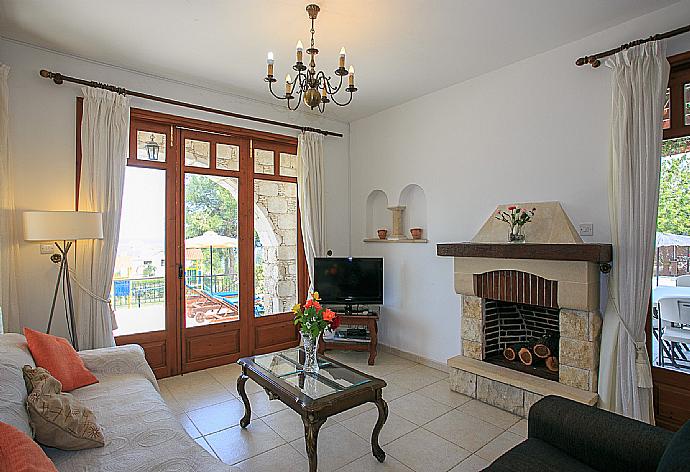 Living room with WiFi, TV, DVD player and terrace access . - Villa Ariadne . (Photo Gallery) }}