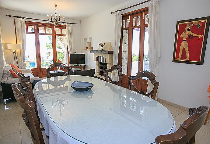 Dining and living area with terrace access . - Villa Ariadne . (Photo Gallery) }}