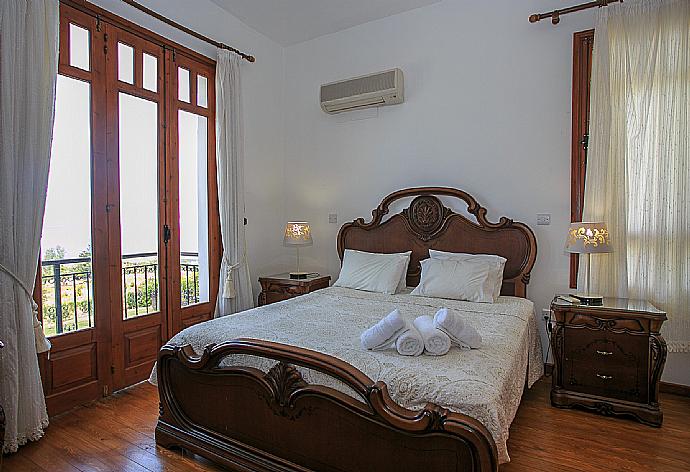 Double bedroom with A/C, en suite bathroom and balcony access . - Villa Ariadne . (Photo Gallery) }}