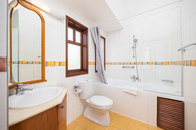 En suite bathroom with bath and shower . - Villa Ariadne . (Photo Gallery) }}