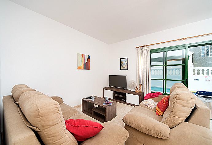 Living room with sofas, dining area, WiFi internet, satellite TV, and DVD player . - Villa Isla De Lobos . (Галерея фотографий) }}