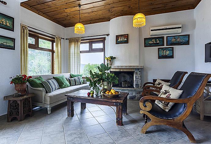 Open-plan living room with sofas, dining area, kitchen, ornamental fireplace, A/C, WiFi internet, satellite TV, and sea views . - Villa Raches . (Galerie de photos) }}