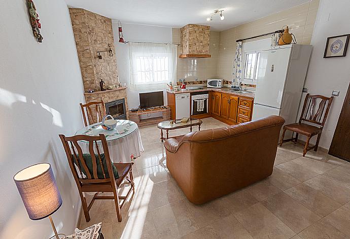 Living room has sofas, WiFi Internet, Satellite TV, DVD player, dining area and ornamental fire place and Equipped kitchen . - Villa Naiara . (Photo Gallery) }}