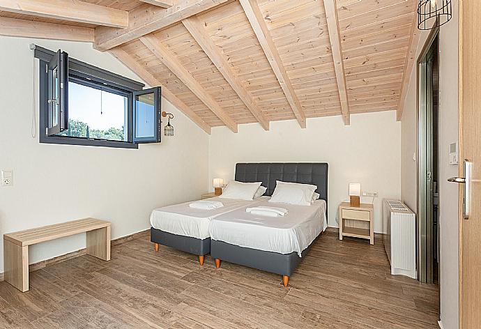 Twin bedroom with en suite bathroom, sofa, desk, and A/C . - Villa Eleanna . (Fotogalerie) }}