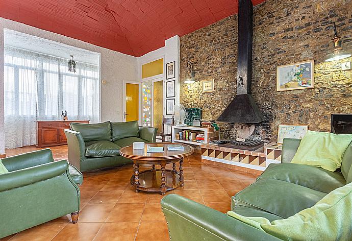 Living room with sofas, dining area, ornamental fireplace, WiFi internet, satellite TV, DVD player, and terrace access . - Villa Satalaia . (Photo Gallery) }}