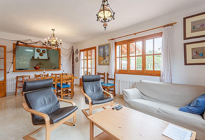 Open-plan living room with sofas, dining area, kitchen, WiFi internet, satellite TV, DVD player, and terrace access . - Villa Isabel . (Galleria fotografica) }}