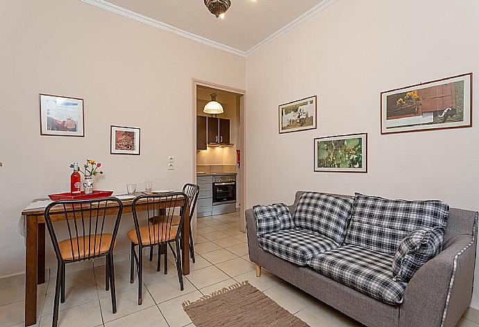 Living room with sofa, dining area, ornamental fireplace, A/C, WiFi internet, satellite TV, and DVD player . - Foteini Apartment . (Fotogalerie) }}