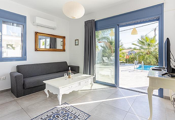 Open-plan living room with sofa, dining area, kitchen, A/C, WiFi internet, satellite TV, and terrace access . - Villa Starfish . (Fotogalerie) }}