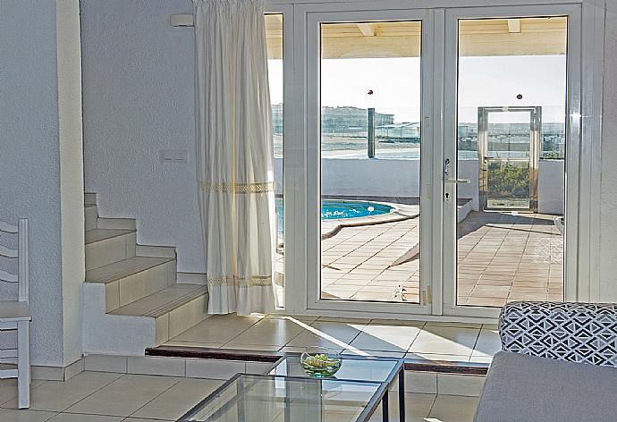 Living room with pool access  . - Villa Remos Ocho . (Галерея фотографий) }}