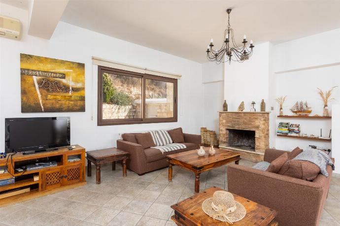 Open-plan living room with sofas, dining area, kitchen, ornamental fireplace, A/C, WiFi internet, and satellite TV . - Villa Heaven . (Fotogalerie) }}