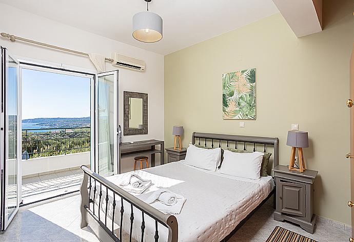 Double bedroom with A/C and upper terrace access with sea views . - Villa Erasmia . (Photo Gallery) }}