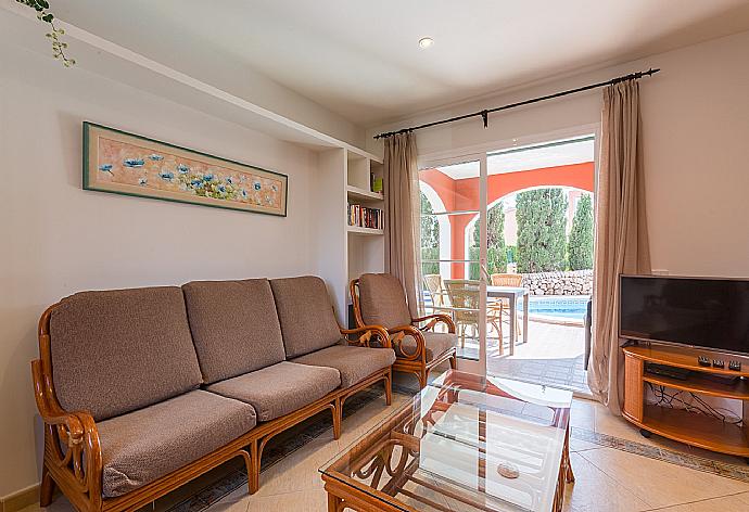 Open-plan living room with dining area, A/C, WiFi Internet, Satellite TV, DVD player, and terrace access  . - Villa Cala Galdana 7 . (Photo Gallery) }}