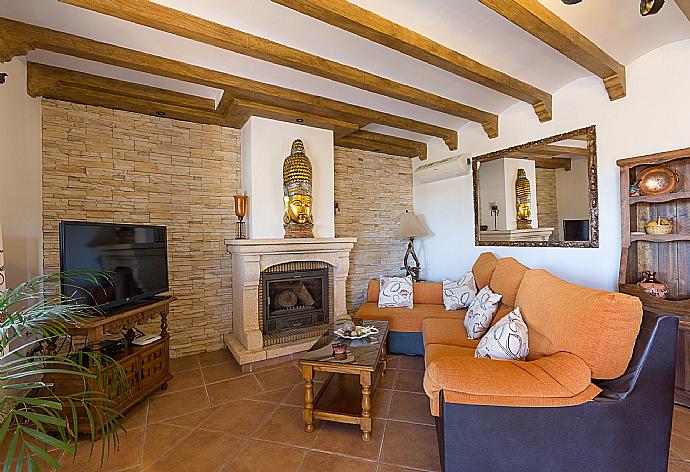 Living room with sofas, WiFi Internet, Satellite TV, DVD player, dining area and ornamental fire place. . - Villa Rosandra . (Photo Gallery) }}