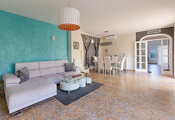 Open-plan living room with has sofas, WiFi Internet, Satellite TV, DVD player, dining area and ornamental fire place. . - Villa Mijas . (Photo Gallery) }}