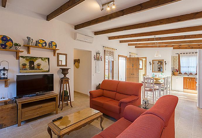 Living room with A/C, sofas, dining area, kitchen, ornamental fireplace, WiFi internet, satellite TV, and pool terrace access . - Villa La Rambla (Oasis) . (Photo Gallery) }}