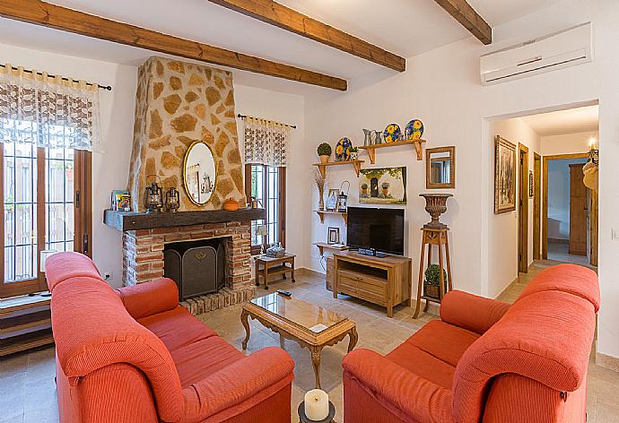Living room with A/C, sofas, dining area, kitchen, ornamental fireplace, WiFi internet, satellite TV, and pool terrace access . - Villa La Rambla (Oasis) . (Photo Gallery) }}