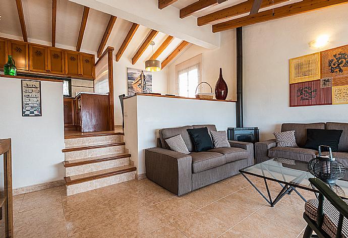 Open-plan living room with sofas, dining area, kitchen, WiFi internet, satellite TV, DVD player, and terrace access . - Villa Es Llaut . (Galerie de photos) }}