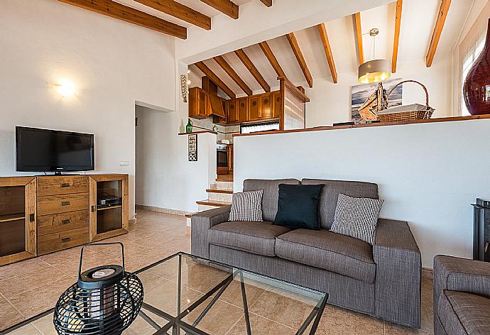 Open-plan living room with sofas, dining area, kitchen, WiFi internet, satellite TV, DVD player, and terrace access . - Villa Es Llaut . (Галерея фотографий) }}