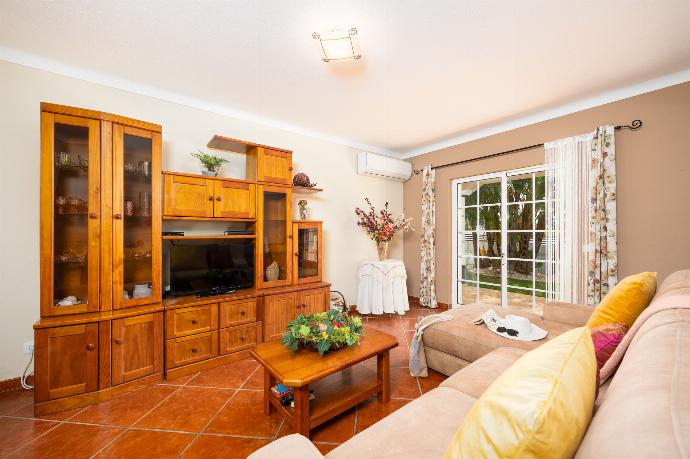 Living room with sofa, dining area, ornamental fireplace, A/C, WiFi internet, and satellite TV . - Villa Amendoeira . (Photo Gallery) }}