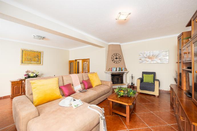Living room with sofa, dining area, ornamental fireplace, A/C, WiFi internet, and satellite TV . - Villa Amendoeira . (Photo Gallery) }}