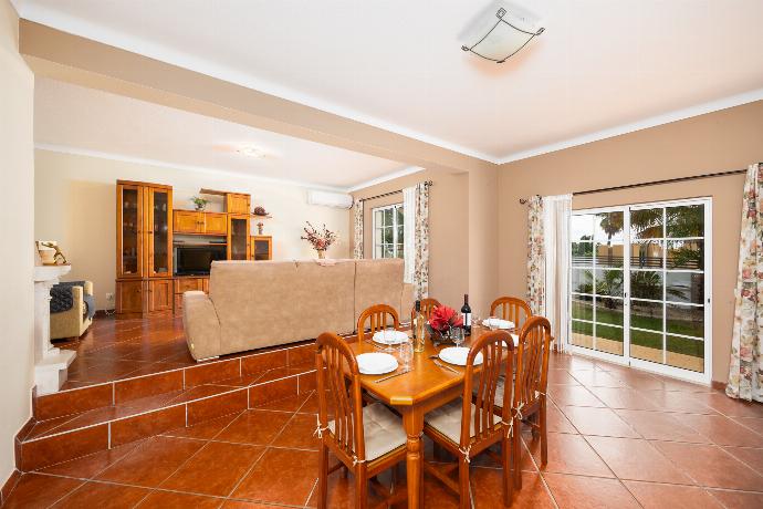 Living room with sofa, dining area, ornamental fireplace, A/C, WiFi internet, and satellite TV . - Villa Amendoeira . (Photo Gallery) }}