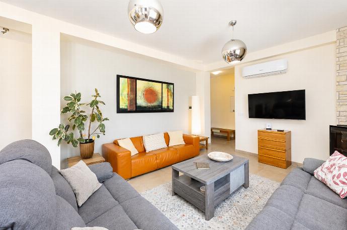 Bright living room with comfortable sofas, modern decor, and a stylish relaxing atmosphere. . - Villa Christel . (Photo Gallery) }}