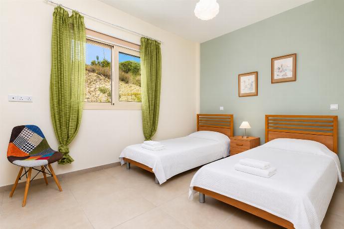 Twin bedroom on ground floor with en suite bathroom and A/C . - Villa Christel . (Photo Gallery) }}