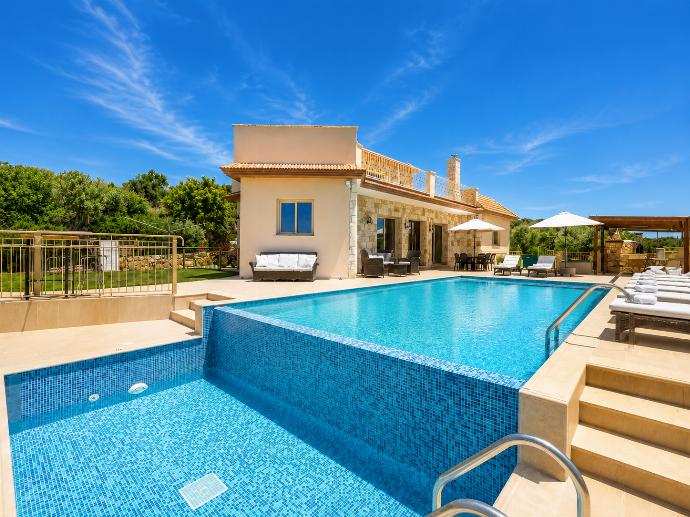 Large private pool with a beautiful stone villa, sun loungers, and a bright Mediterranean setting. . - Villa Christel . (Photo Gallery) }}