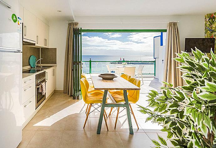 Open-plan living room with sofas, dining area, kitchen, A/C, WiFi internet, satellite TV, and sea views . - Sea Breeze Apartment . (Fotogalerie) }}