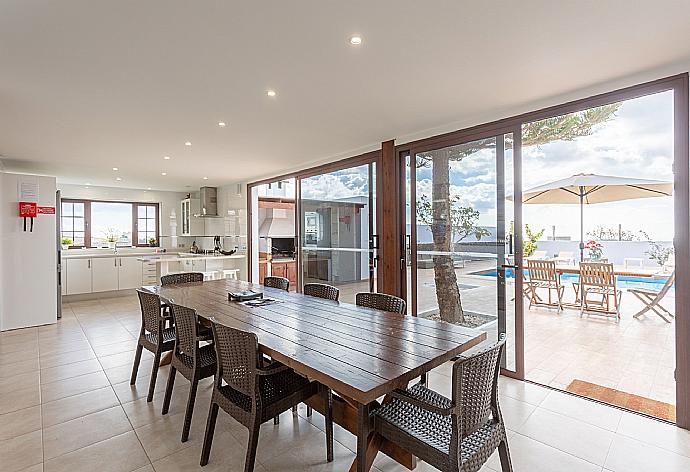 Open-plan living room with sofas, dining area, kitchen, ornamental fireplace, WiFi internet, satellite TV, DVD player, and pool terrace access . - Villa Santana . (Galería de imágenes) }}