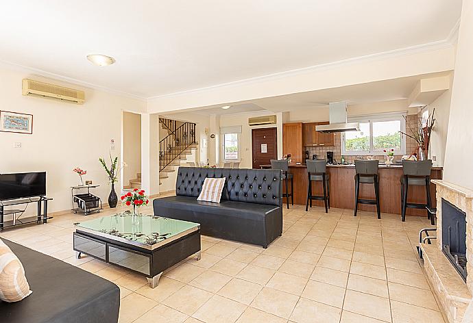 Open-plan living room with sofa, dining area, kitchen, ornamental fireplace, A/C, WiFi internet, and satellite TV . - Villa Solis . (Photo Gallery) }}