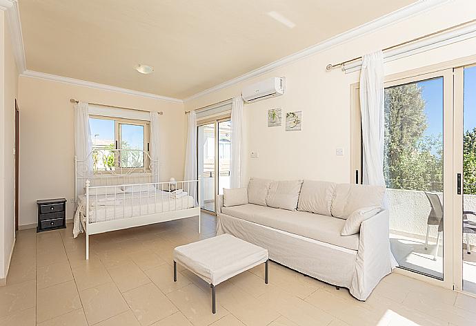 Double bedroom with en suite bathroom, sofa, A/C, and balcony access with sea views . - Villa Andree . (Photo Gallery) }}