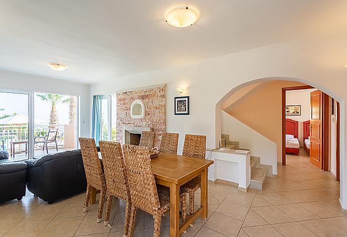 Open-plan living room with sofas, dining area, kitchen, ornamental fireplace, A/C, WiFi internet, satellite TV, and terrace access . - Villa Astro . (Galleria fotografica) }}