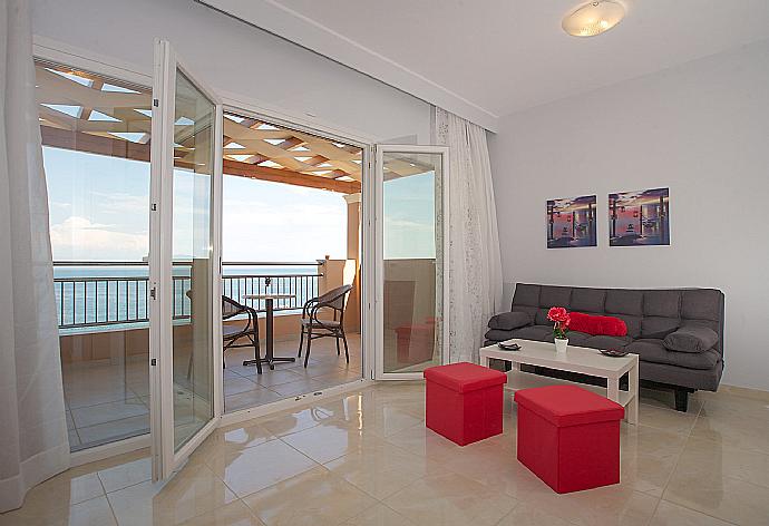 Double bedroom with en suite bathroom, A/C, living area, and balcony access with panoramic sea views . - Villa Bacante . (Fotogalerie) }}