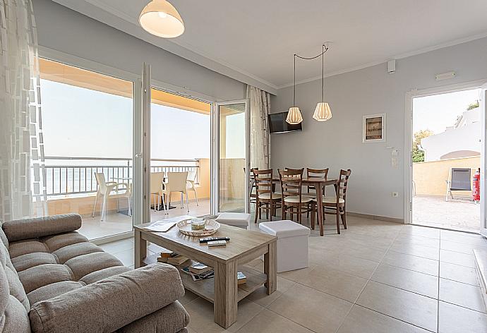 Open-plan living room with dining area, kitchen, A/C, WiFi internet, satellite TV, and terrace and balcony access . - Villa Aurora . (Photo Gallery) }}